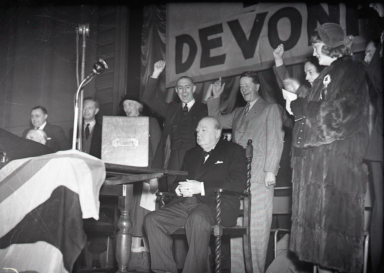 Plymouth Devonport election, 1950. Winston Churchill sat by ballot box with dignitaries. © Plymouth Arts and Heritage Service