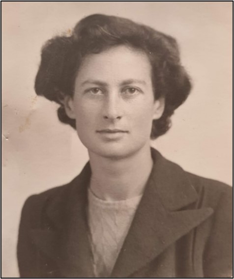 A sepia photograph of the bust and head of Margaret Agerholm. She is looking front. She has short, dark hair, and is wearing a top and jacket.