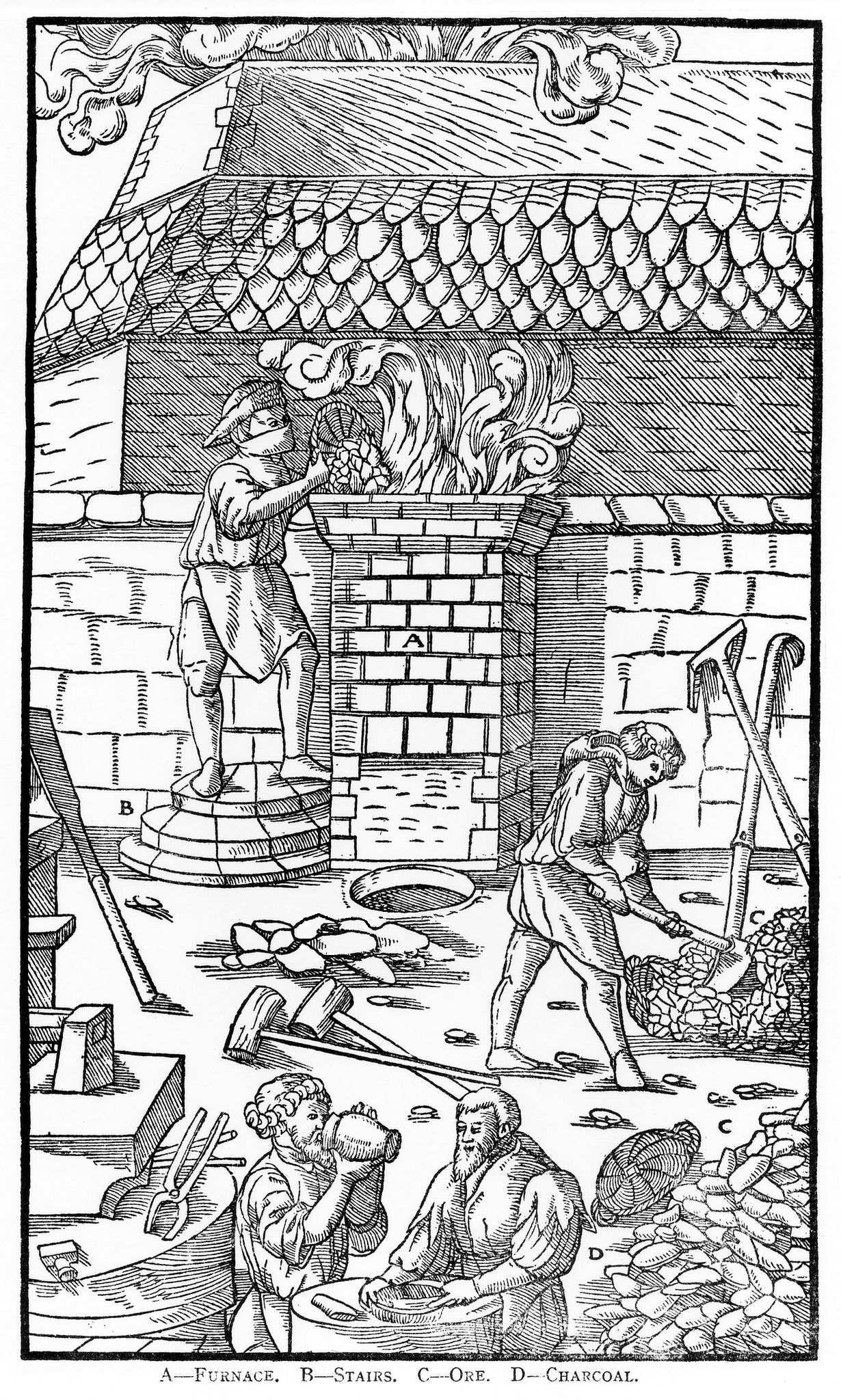 Black and white. There is an iron furnace in the background with a fire pit in the shape of a column that smoke is billowing from. There is a man stood next to this put on steps pouring in charcoal. He is wearing a hat and a mask. There is a man in front that is collecting the charcoal. At the very front of the image are two men having a drink and some food. There are tools strewn about on the floor and leant against walls.