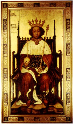 A portrait of a king. The background and frame are gold coloured. The frame also has dark rectangles alternating with the gold colour. The King has a crown on his head and is holding and orb and sceptre. He has red robes with a white fur trim, the fur covers the top half of his chest. He is wearing red shoes. He is sat down on a brown throne. 