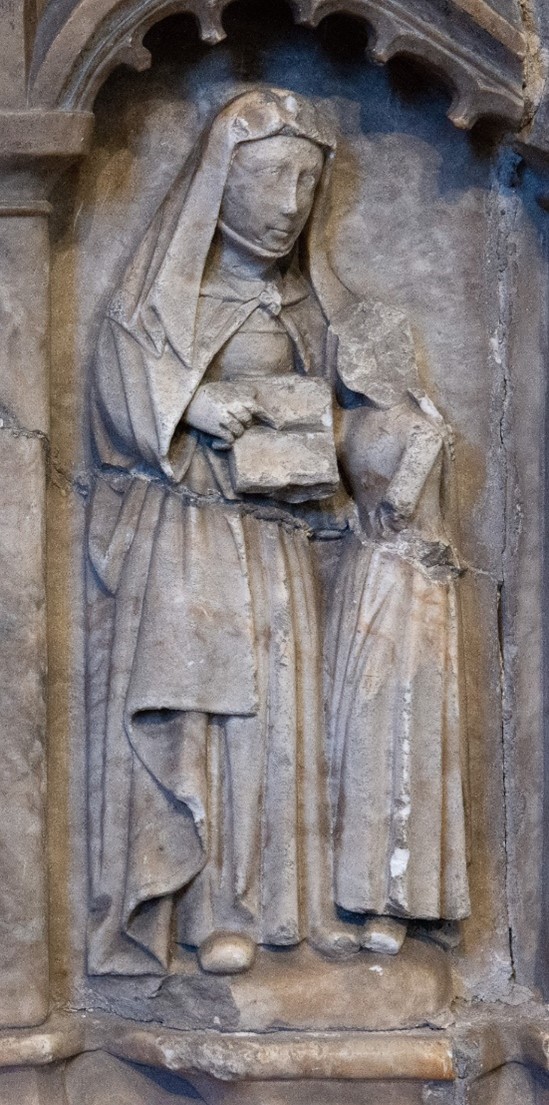 A panel of a tomb that depicts a woman teaching a girl how to read.