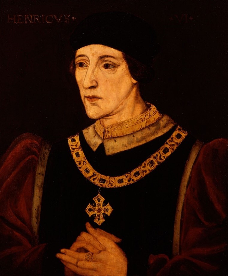A portrait of a white man wearing robes and a gold chain with a cross. His hands are clasped together.