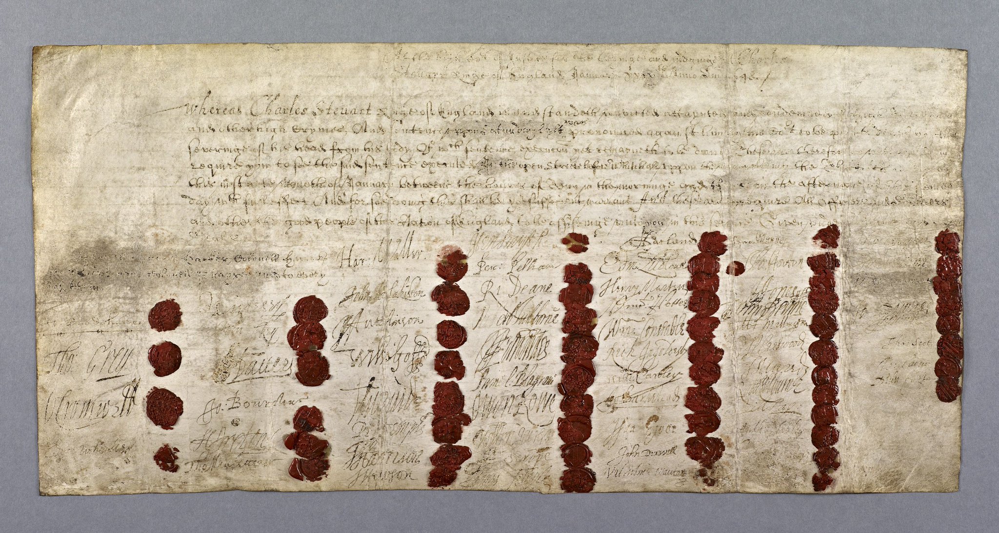 An old stained document. The writing is faded. At the top is a paragraph stating that the execution of Charles I should be done on 30 January in the open street outside Whitehall. There are 59 signatures and seals.