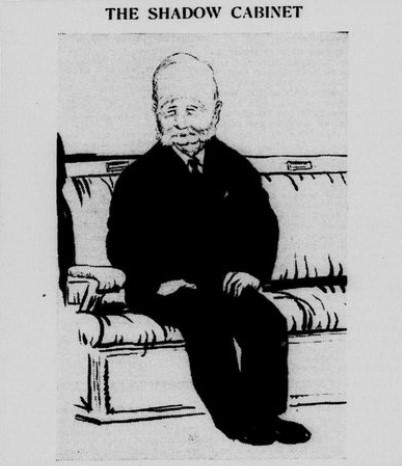 Black and white cartoon drawing of a man in a black suit sitting alone on an upholstered bench. He has a mutton chop beard. The image is captioned 'The Shadow Cabinet'. No one else is in the image.