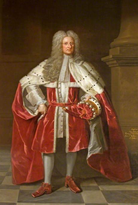 A full length portrait of a man standing on a chequered black and white floor weating coronation robes. He is weating red heeled shoes and silver tights, and a red velvet knee length jacekt with a high belt and a long red velvet robe, lined with ermine over the shoulders to the elbow. In his left hand he is holding a matching red velvet and ermine hat. He has a long grey curly wig and is clean shaven. 