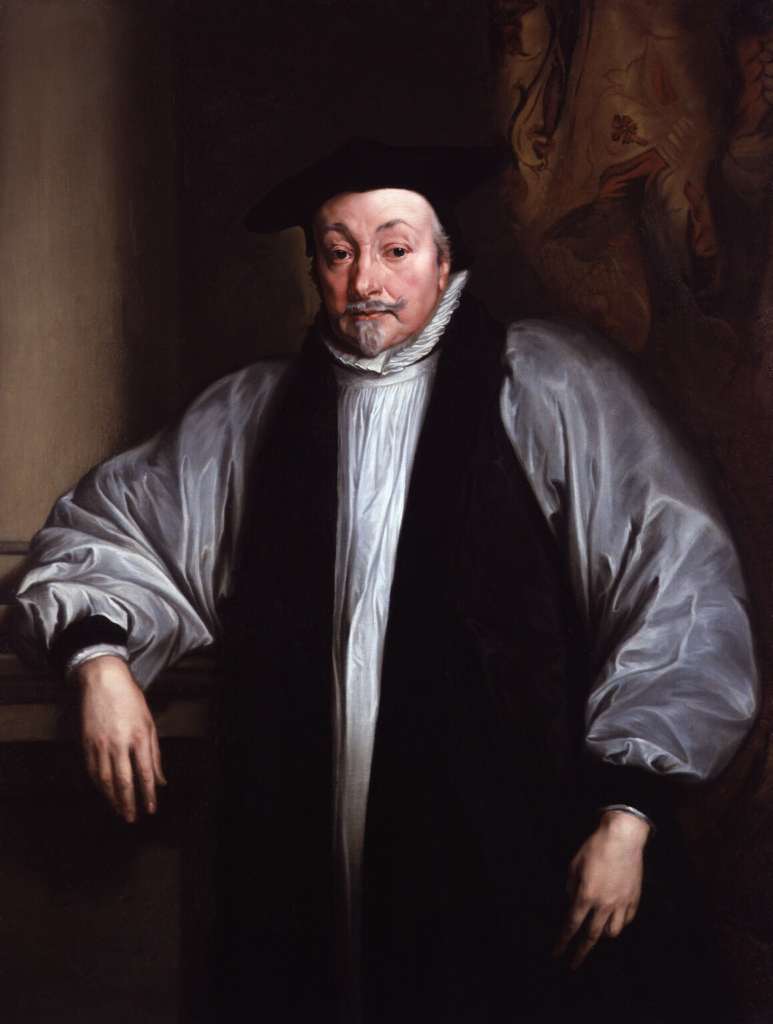 Portrait of William Laud, Archbishop of Canterbury. Laud is wearing a white flowing shirt and black robes, a white frill and a black cap. He has a grey moustache and goatee beard. 