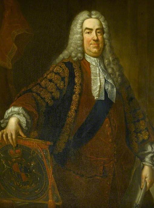 A three-quarter length painted portrait of Robert Walpole. Standing, he is wearting a lighbter brown buttoned jacket and a white frilled necktie, with a dark cloak with golden decoration. He is clean shaven wearing a long grey curled wig. 