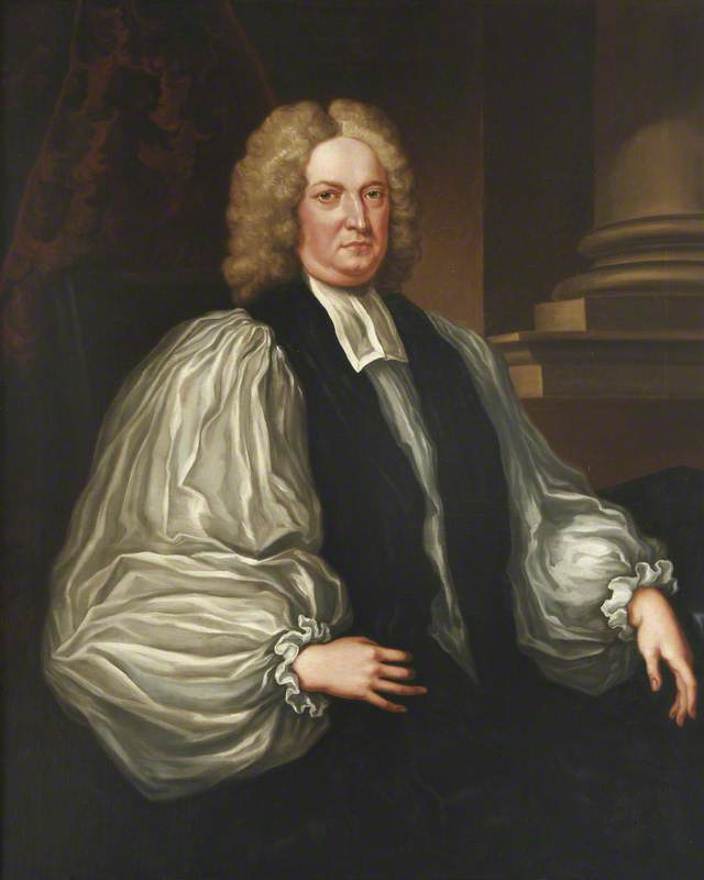 A half-length painted portrait of Edmund Gibson. Sitting down he is wearing a white rochet and black chimere. He is clean shaven wearing a grey curled wig. 